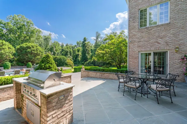 a front view of house with a garden and patio