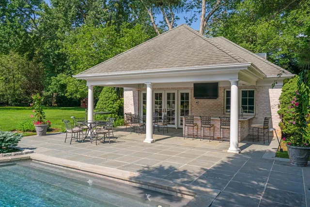 a view of a patio with dining table and chairs