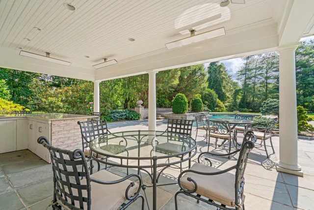a living room with furniture a wooden floor and a large window