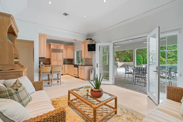 a living room with furniture a refrigerator and dining table