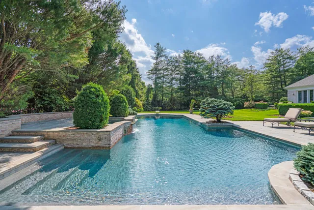 a view of a house with a yard and sitting area
