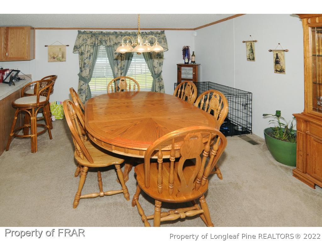 5117 Maxwell Road Stedman, NC 28391 - Photo 3 of 20 a dining room with furniture and a floor to ceiling window