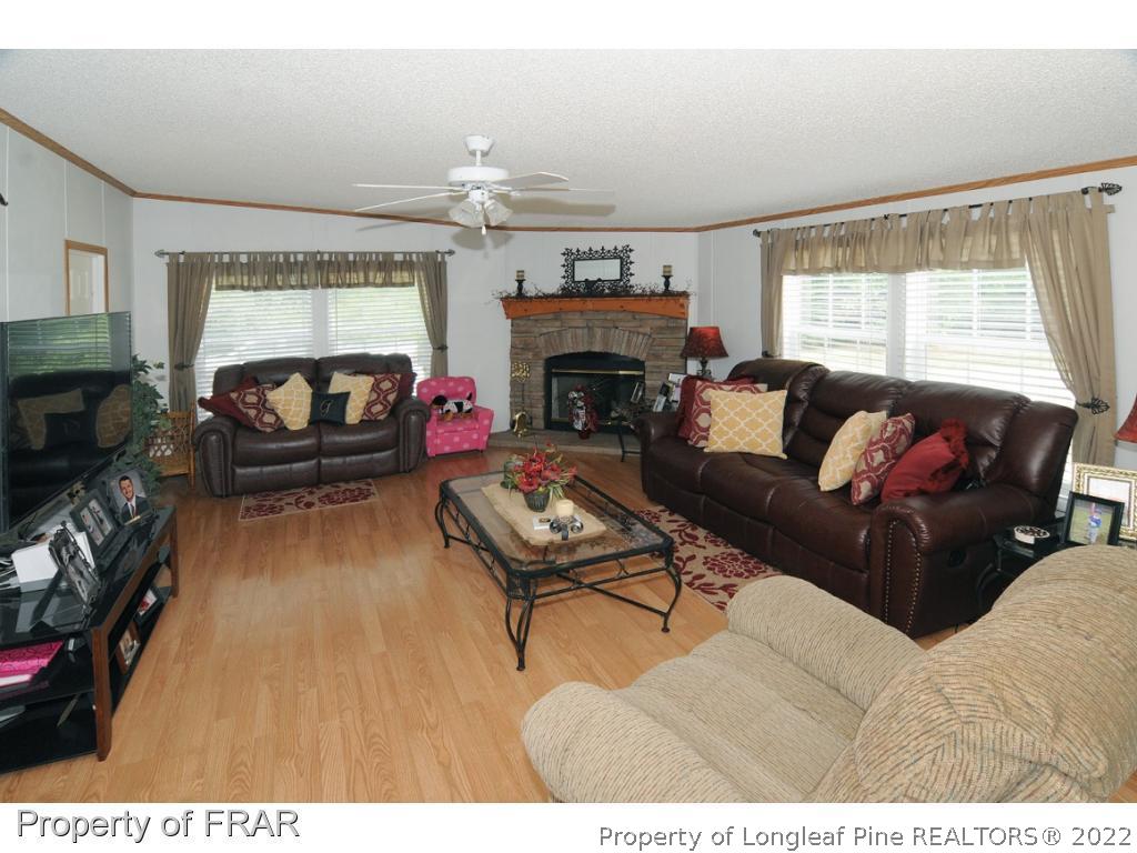 5117 Maxwell Road Stedman, NC 28391 - Photo 5 of 20 a living room with furniture and a fireplace