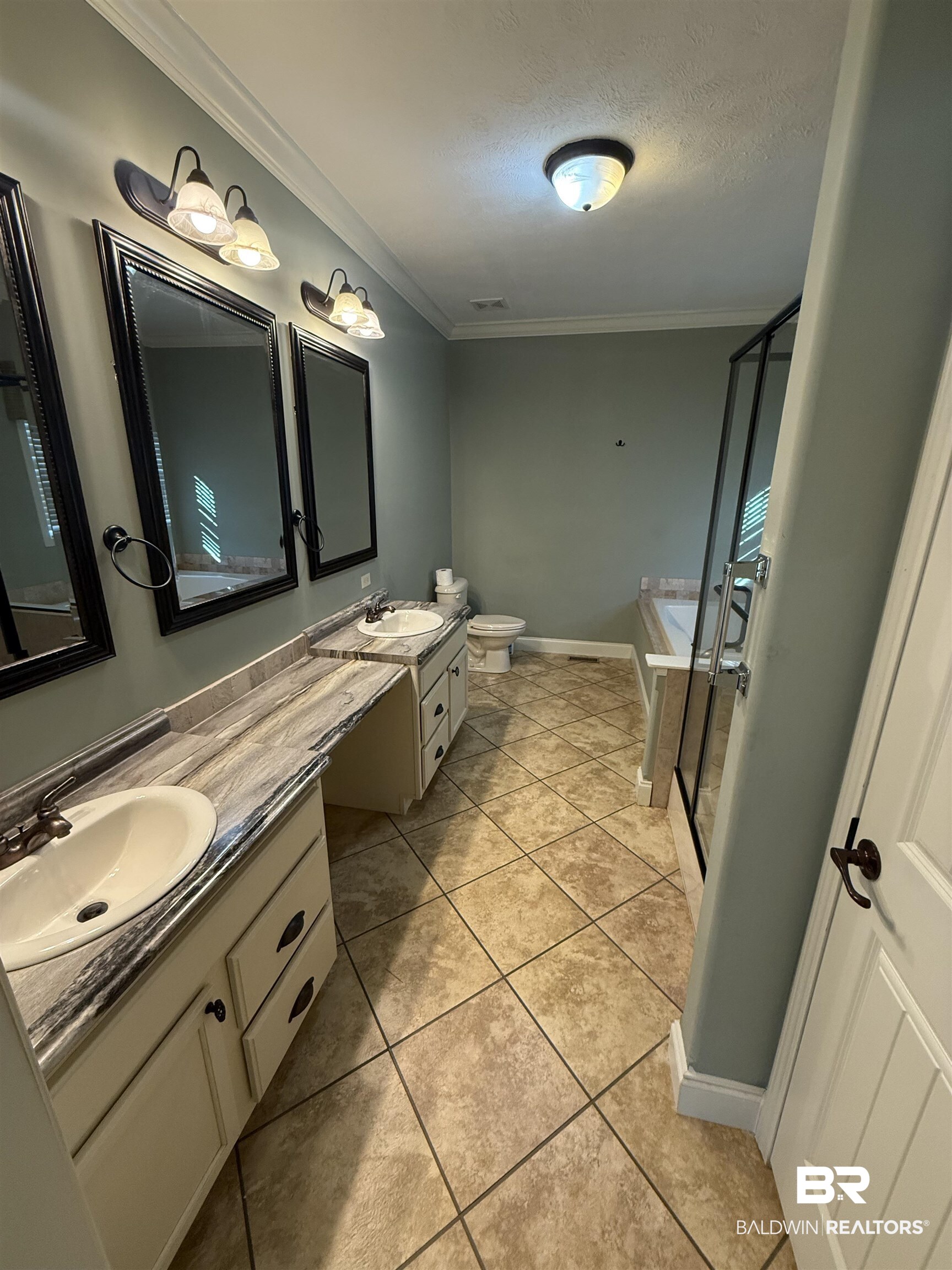 1274 Caney Loop Lillian, AL 36549 - Photo 15 of 19 Full bath featuring double vanity, ornamental molding, a shower stall, a bathtub, and a textured ceiling