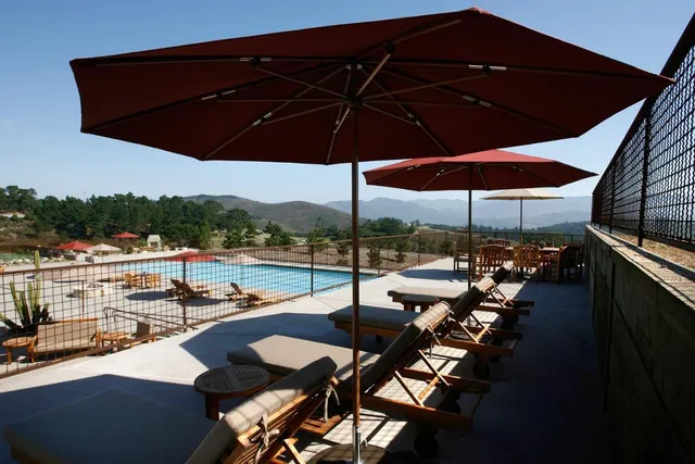 a view of a outdoor sitting area with furniture and umbrella