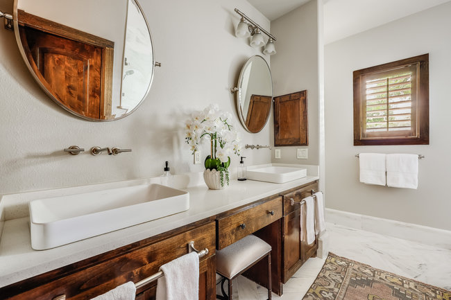 2913 Cherry Lane, Unit A Austin, TX 78703 - Photo 12 of 19 a bathroom with a sink a mirror a vanity and a bathtub