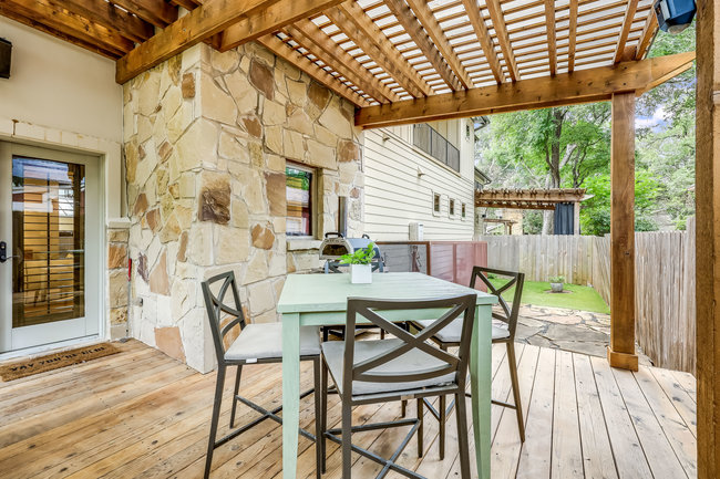 2913 Cherry Lane, Unit A Austin, TX 78703 - Photo 13 of 19 a view of a patio with table and chairs and wooden floor