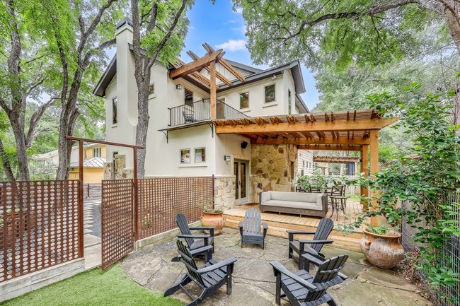 2913 Cherry Lane, Unit A Austin, TX 78703 - Photo 15 of 19 a view of a patio with a table and chairs and wooden fence