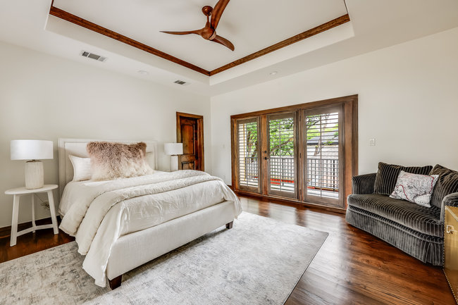 2913 Cherry Lane, Unit A Austin, TX 78703 - Photo 10 of 19 a spacious bedroom with a bed couch and a large window