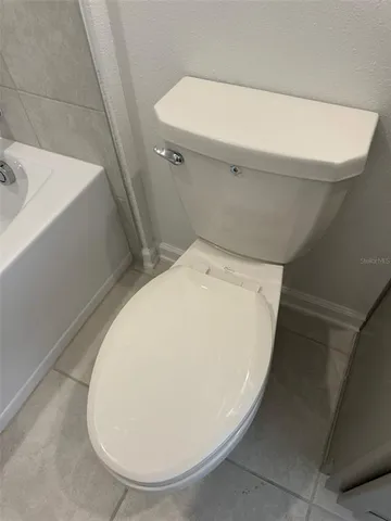 a bathroom with a double vanity sink toilet and shower