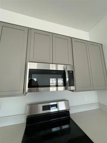 a kitchen with wooden cabinets and a stove top oven