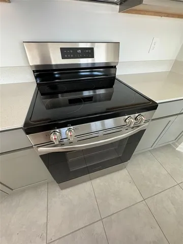 a stove top oven sitting inside of a kitchen