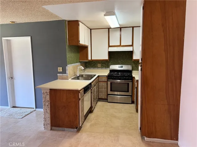 a kitchen with stainless steel appliances granite countertop a stove and a refrigerator