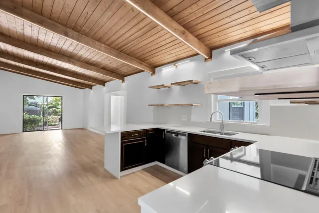 a kitchen with stainless steel appliances granite countertop a sink dishwasher stove and cabinets