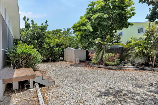 a backyard of a house with table and chairs