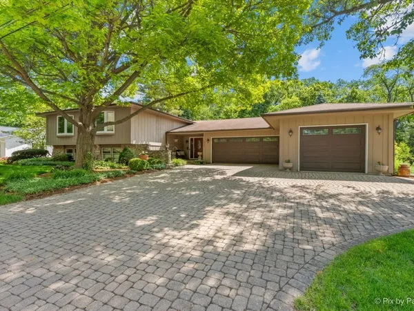 a front view of a house with a yard and a garage