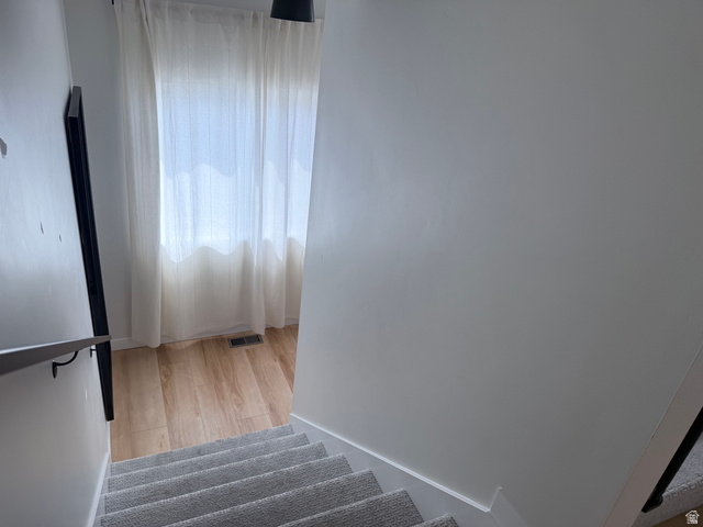 774 West 480 South American Fork, UT 84003 - Photo 36 of 76 Carpeted staircase with a contemporary metal handrail and light-toned wood-finish flooring