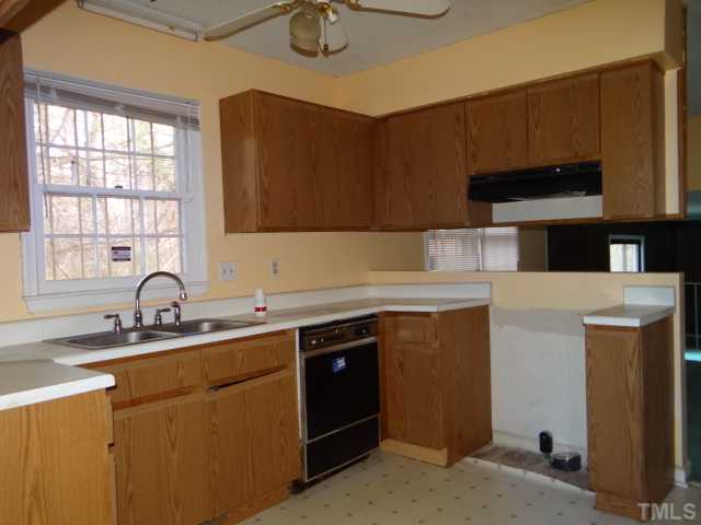 2613 Firelight Road Raleigh, NC 27610 - Photo 5 of 10 a kitchen with stainless steel appliances granite countertop a sink stove and cabinets