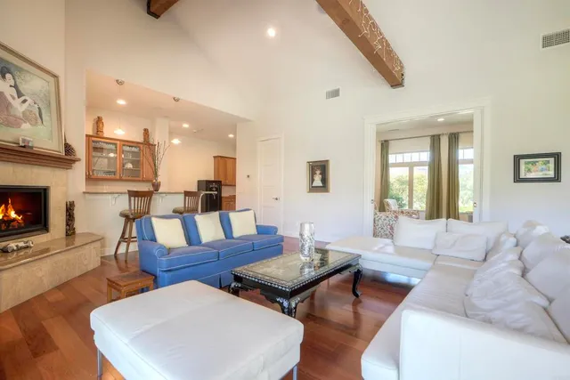 a view of a a dining room with furniture window and wooden floor