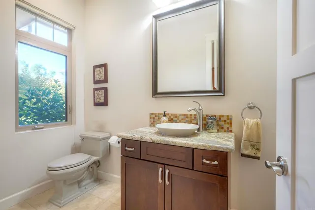 a large kitchen with stainless steel appliances a large counter top a stove and a sink