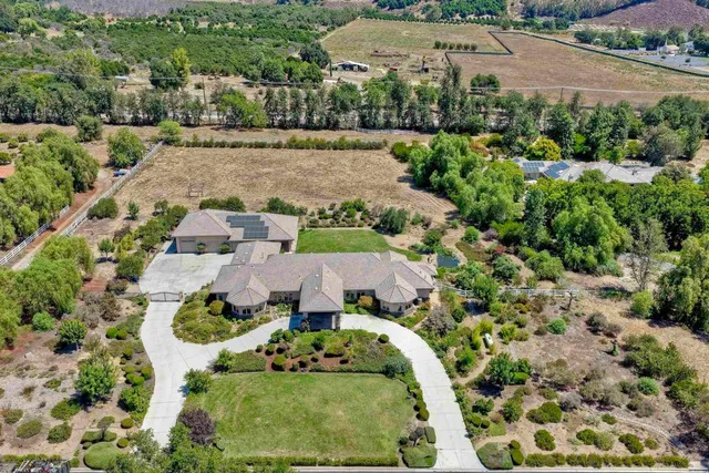 an aerial view of a house with yard swimming pool and outdoor seating