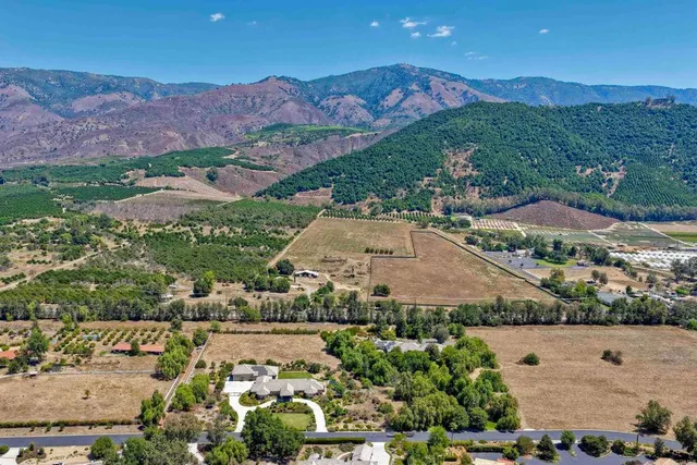 an aerial view of residential houses with outdoor space and street view
