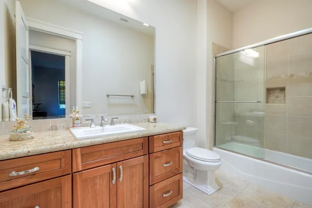 an aerial view of a house with yard and street