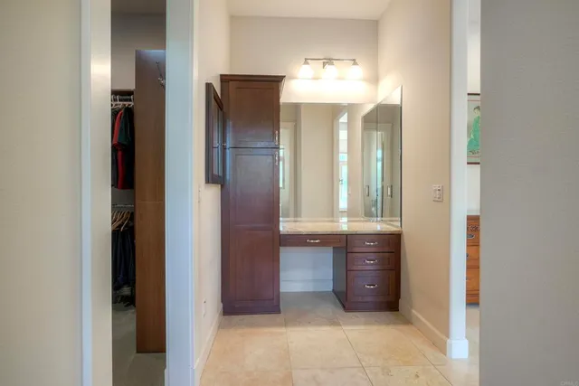 a living room with furniture and a dining table with wooden floor