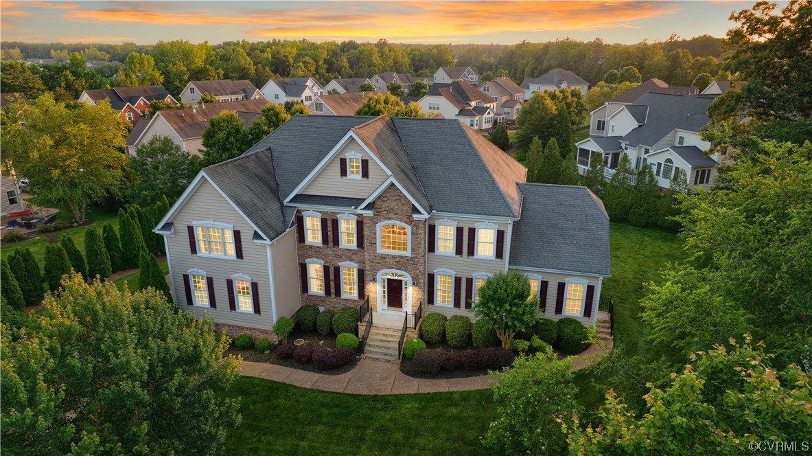 a aerial view of a brick house next to a yard