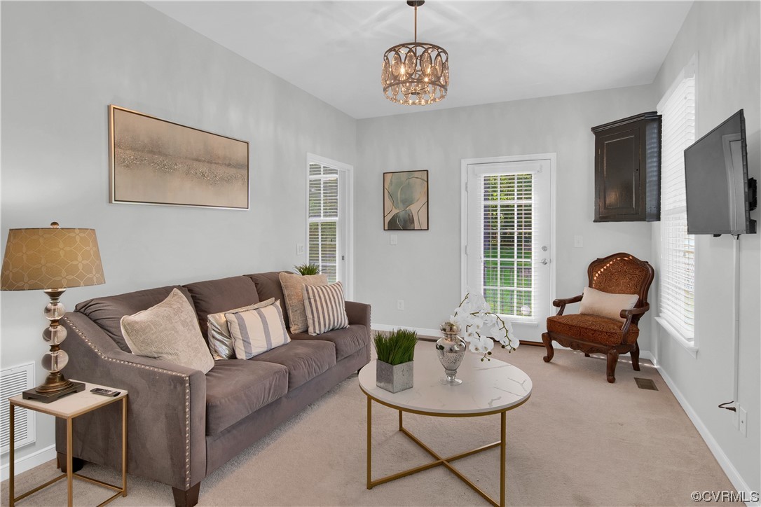 6418 Rivershook Terrace Moseley, VA 23120 - Photo 12 of 44 a living room with furniture a flat screen tv and a window