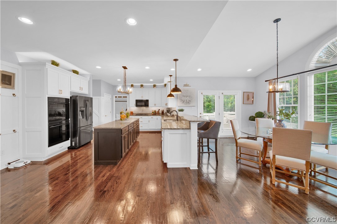 6418 Rivershook Terrace Moseley, VA 23120 - Photo 20 of 44 a large kitchen with cabinets table and chairs
