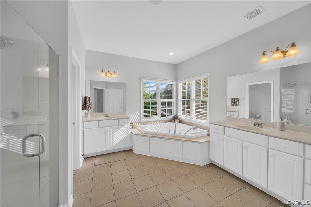 6418 Rivershook Terrace Moseley, VA 23120 - Photo 29 of 44 a spacious bathroom with a granite countertop sink mirror and bathtub
