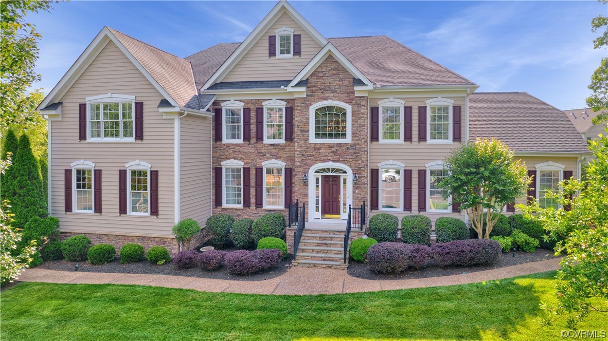 6418 Rivershook Terrace Moseley, VA 23120 - Photo 3 of 44 a front view of a house with a garden and plants