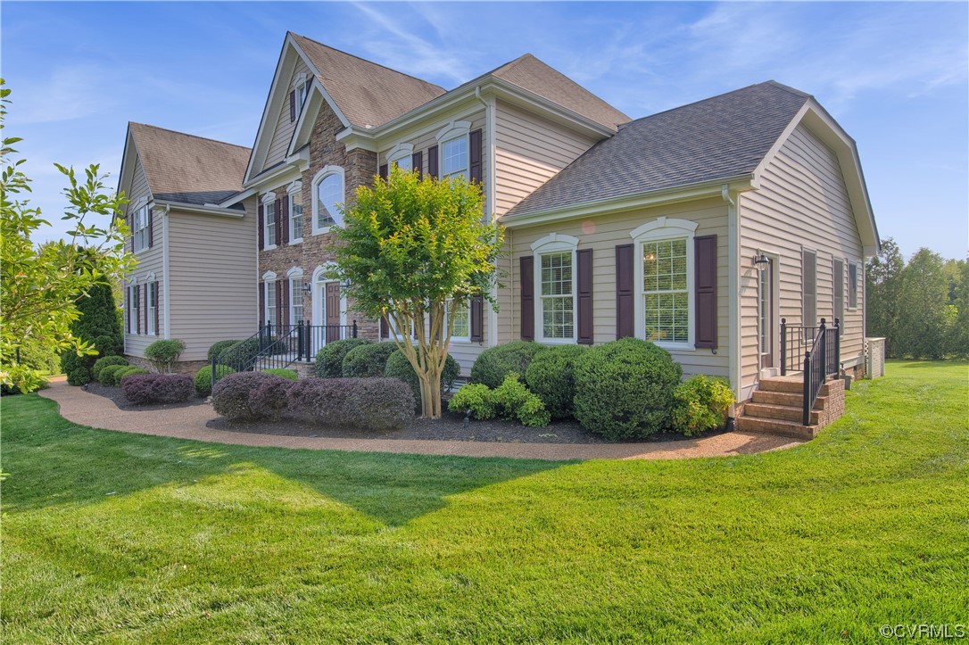 6418 Rivershook Terrace Moseley, VA 23120 - Photo 4 of 44 a front view of a house with a yard and plants