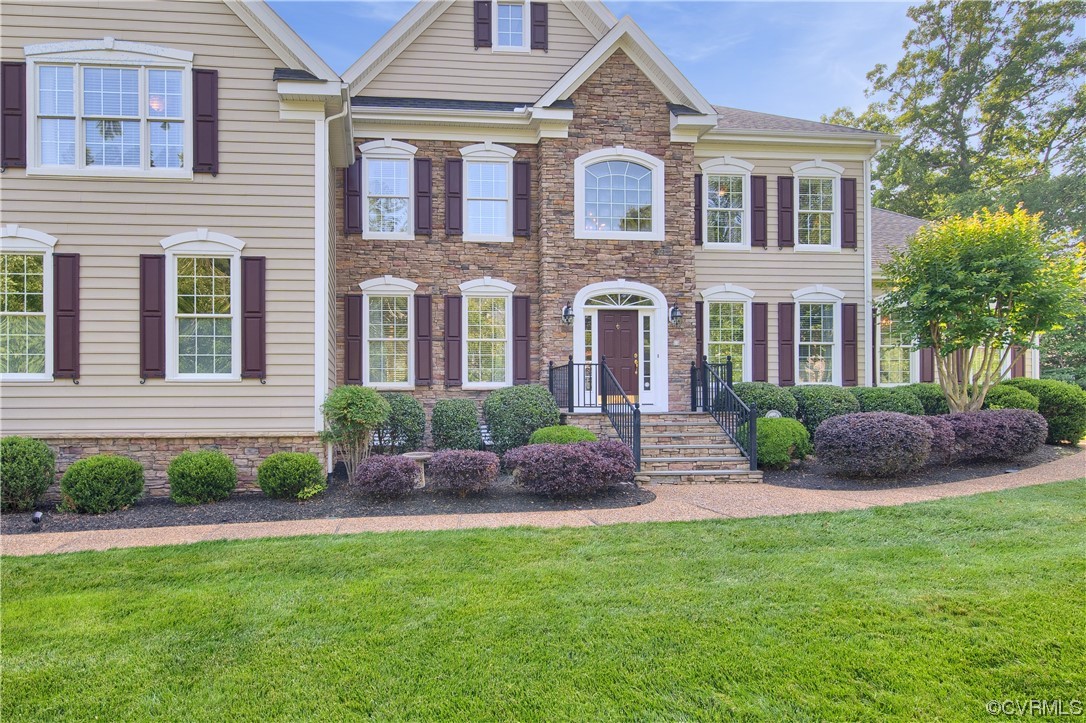 6418 Rivershook Terrace Moseley, VA 23120 - Photo 5 of 44 a front view of a house with a garden and plants