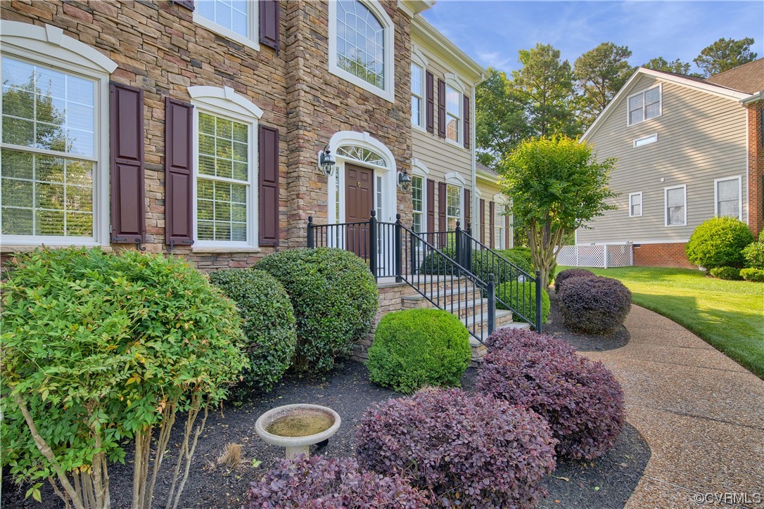 6418 Rivershook Terrace Moseley, VA 23120 - Photo 7 of 44 a view of a multi story house with a yard and plants