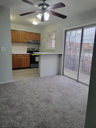 a view of kitchen with sink and refrigerator