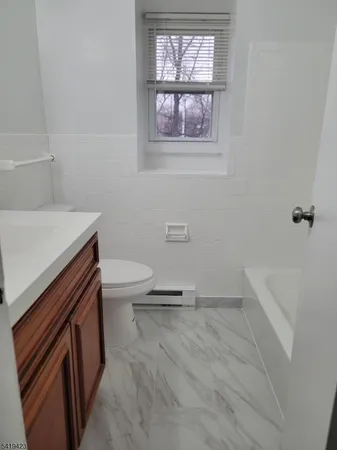 a bathroom with a sink a toilet and tub