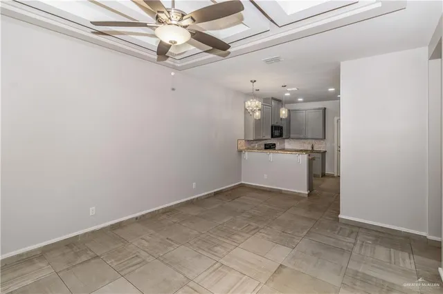 a view of a kitchen with a sink and refrigerator