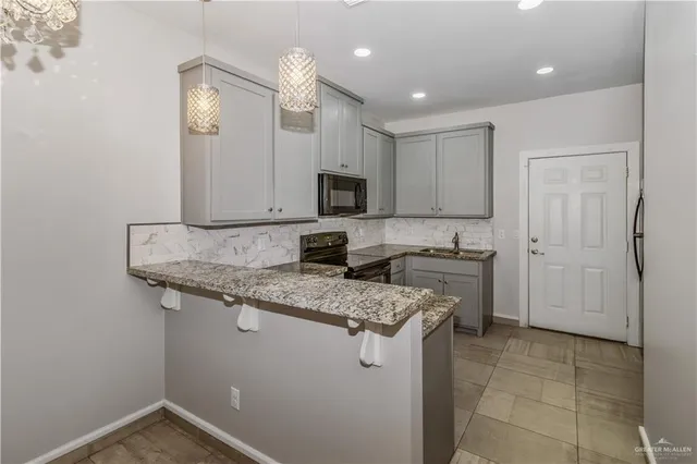 a kitchen with a sink stove and cabinets