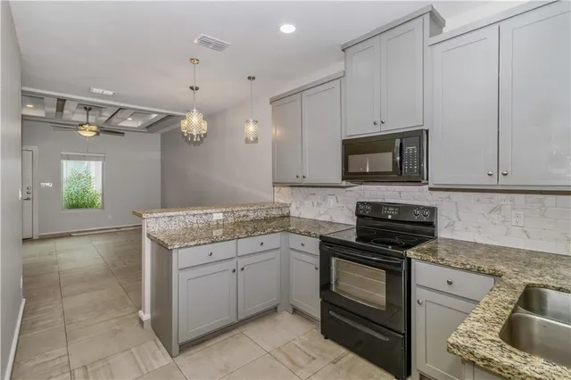 a kitchen with a sink stove and microwave