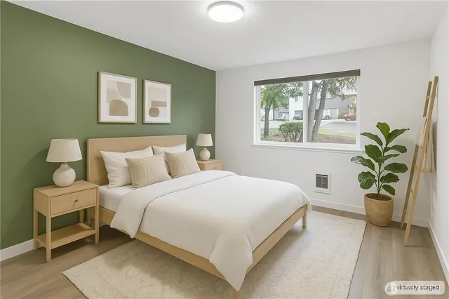 a bedroom with a bed and potted plant