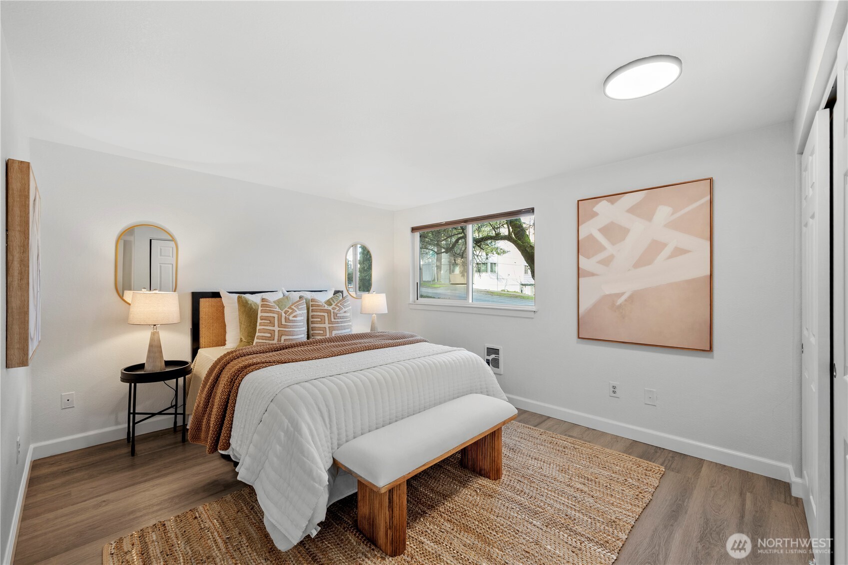 707 North 130th Street, Unit B204 Seattle, WA 98133 - Photo 13 of 21 a bedroom with a bed lamp on table and a window