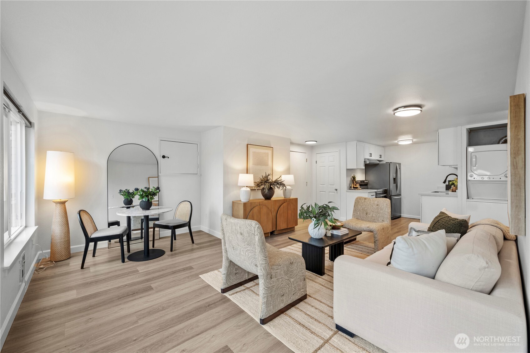 707 North 130th Street, Unit B204 Seattle, WA 98133 - Photo 2 of 21 a living room with furniture and a wooden floor