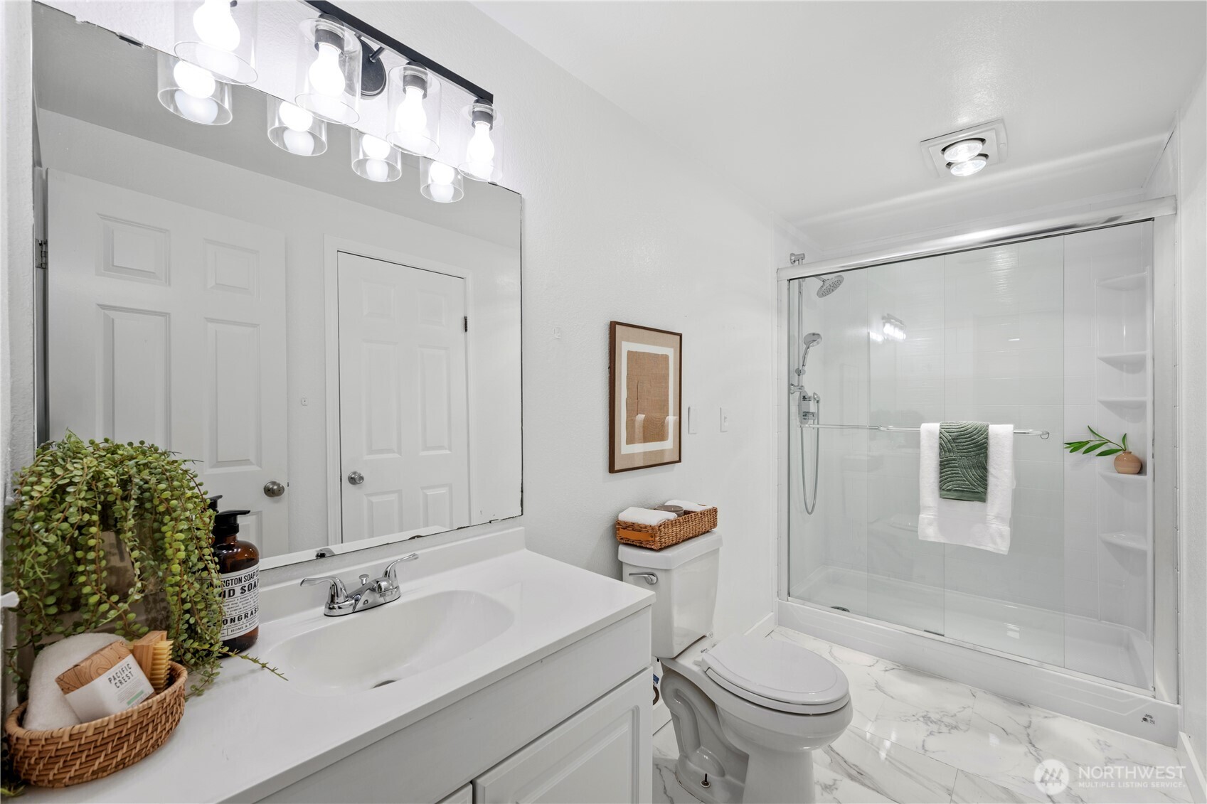 707 North 130th Street, Unit B204 Seattle, WA 98133 - Photo 7 of 21 a bathroom with a sink a toilet and shower