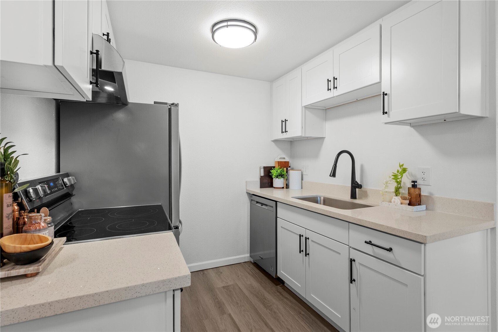 707 North 130th Street, Unit B204 Seattle, WA 98133 - Photo 8 of 21 a kitchen with a sink and cabinets