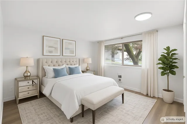 a bedroom with a bed and a potted plant