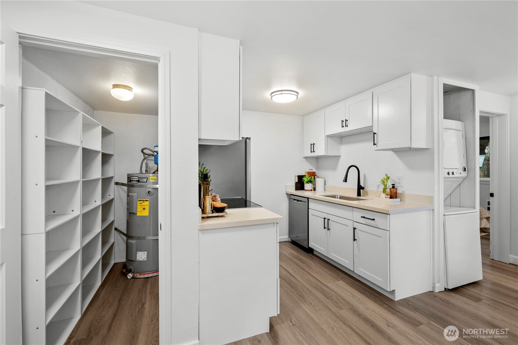 707 North 130th Street, Unit B204 Seattle, WA 98133 - Photo 10 of 21 a kitchen with cabinets and wooden floor