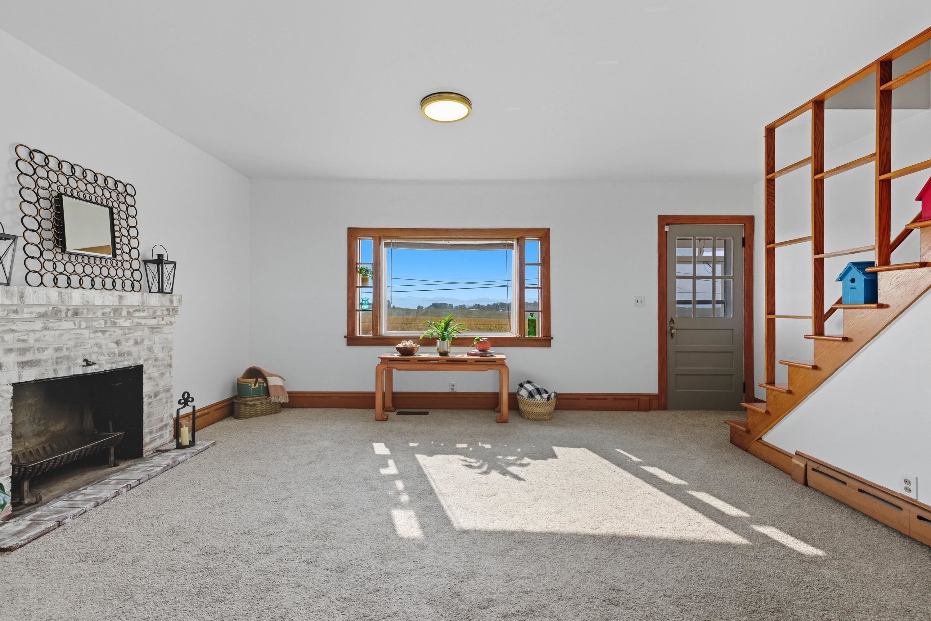 3138 Cross Keys Road Harrisonburg, VA 22801 - Photo 22 of 74 The living room space is located off the entrance to the home and near the steps leading to the upper level. This space features a fireplace, comfortable flooring, updated light fixture, and large windows allowing in an abundance of natural light!