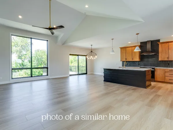 a kitchen with granite countertop a stove and a large window